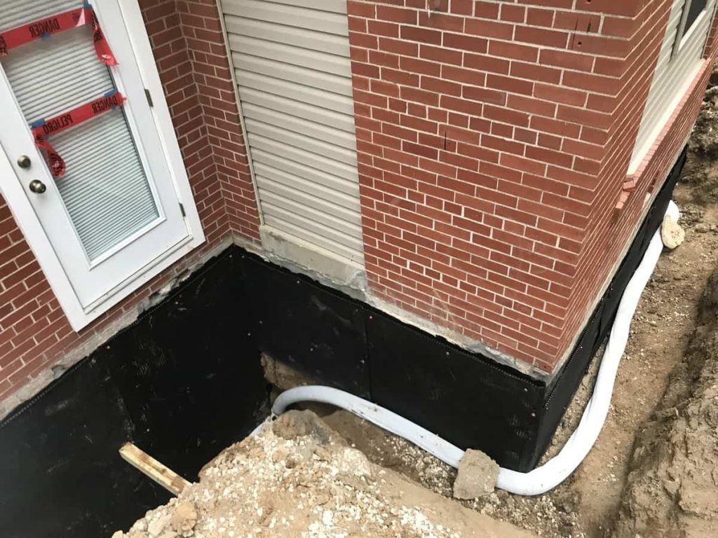 Basement waterproofing on the foundation of a house.