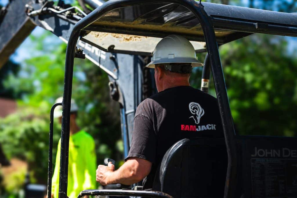 A Ram Jack Contractor running an excavator.