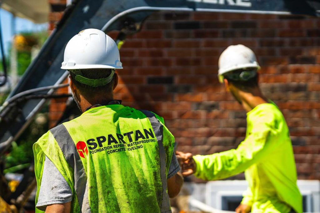 Two Spartan Ram Jack Workers talking about the job.