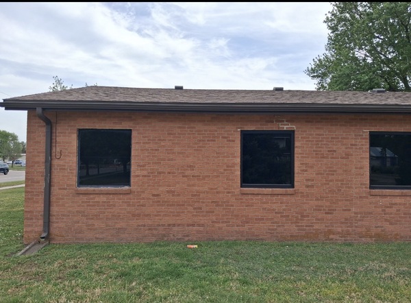 Exterior brick church building in McPherson, KS showing foundation settlement indicators, including stair-step cracking in the brick veneer, before helical pier foundation repair by Spartan Ram Jack of Wichita.