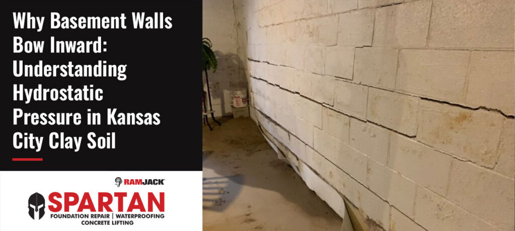 Bowing basement wall in a Kansas City home showing long horizontal cracks and inward movement caused by hydrostatic pressure from saturated clay soil.