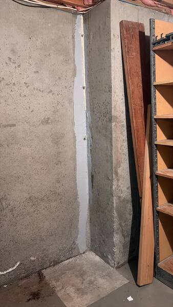 Repaired vertical foundation crack sealed from floor to ceiling on a poured concrete basement wall in Lee's Summit, MO.